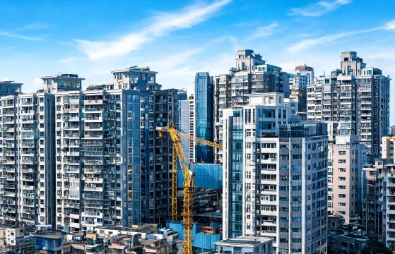 City crane on dense urban construction site